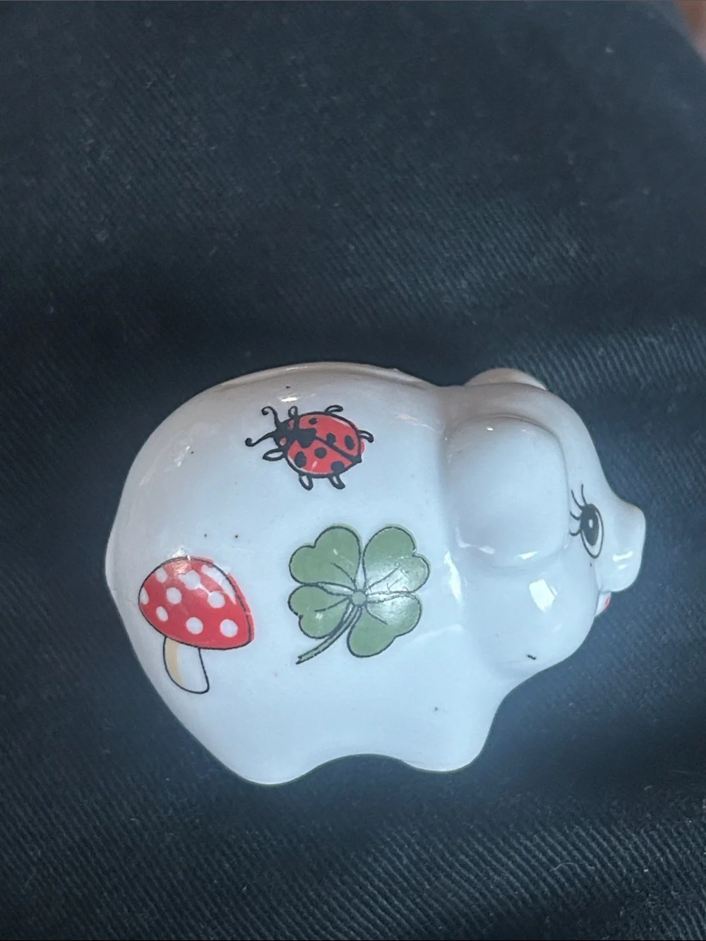 This vintage porcelain piggy bank features a German Good Luck) chimney sweep